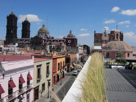 Modern museum on the right; colonial city on the left.