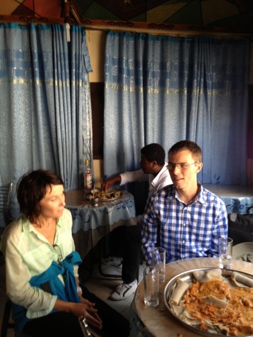 Standard lunch place, with our guide and another tour member. Please note water served in old Stoli bottles. And platter of shiro wat on injera. Just like you expect.